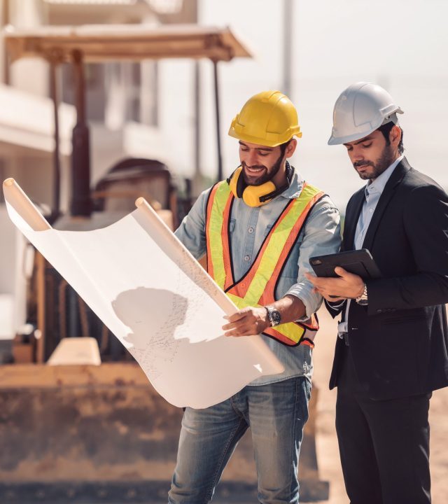 civil-engineer-construction-worker-manager-holding-digital-tablet-blueprints-talking-planing-about-construction-site-cooperation-teamwork-concept-scaled-q0klidq9dakx72rk8g02fu4953y02nrni1q9fi82e8